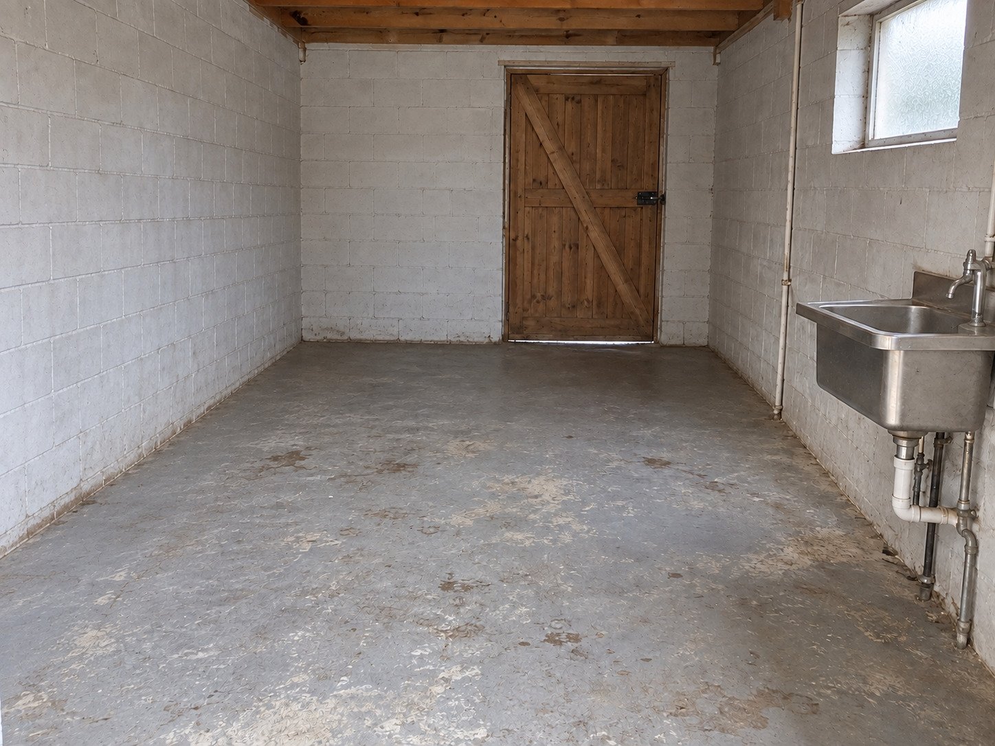 Empty farm packing room after unwanted containers and packaging have been hauled away.