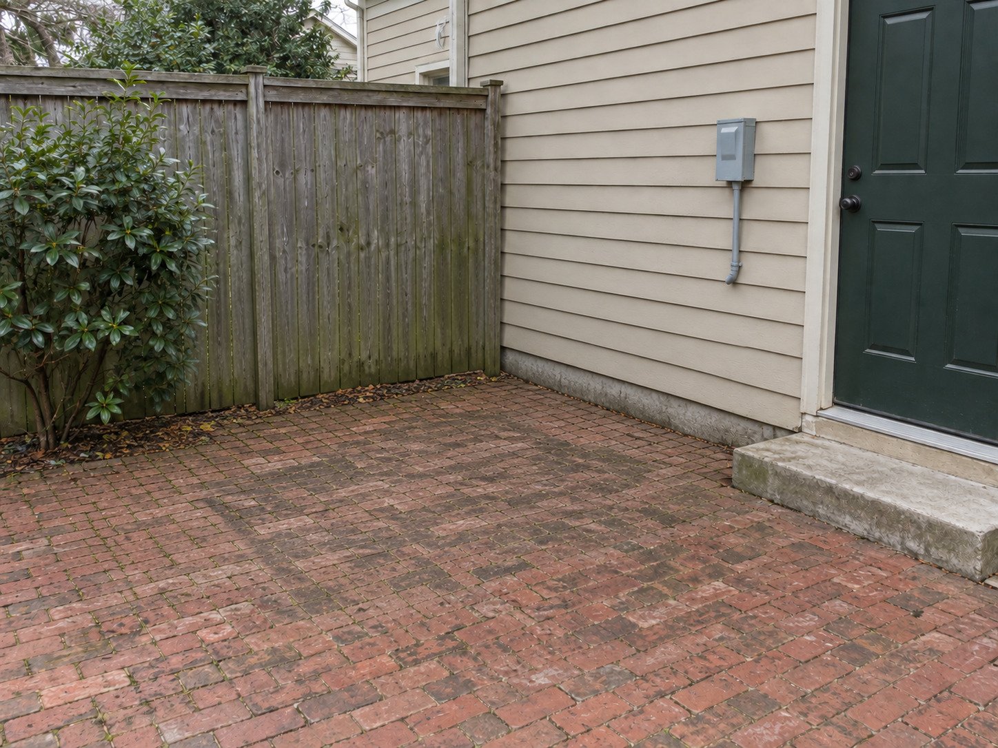 Brick courtyard after removal of an old hot tub and its access steps.