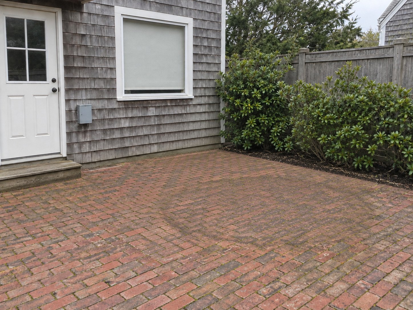 Brick patio after removal of an old round hot tub and its steps.