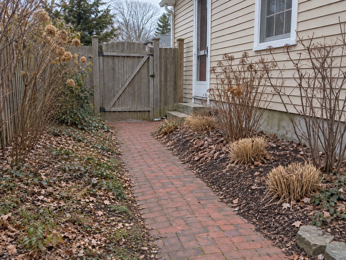 Brick garden path after bags and loose seasonal cuttings have been hauled away.