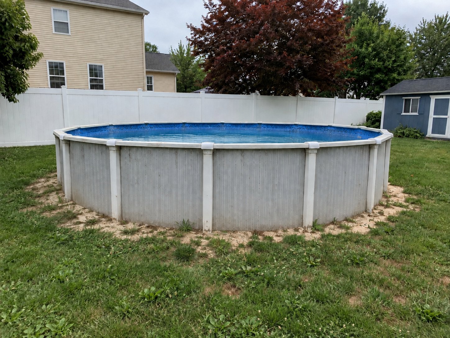 Older round above-ground swimming pool before removal.
