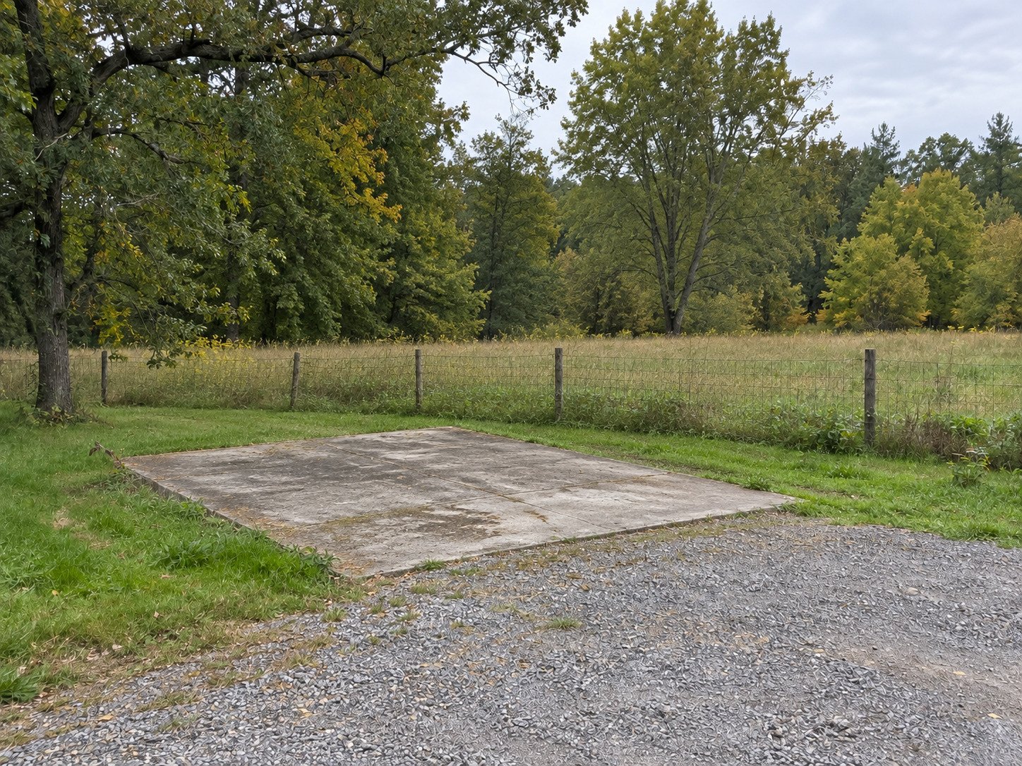 Original concrete floor slab and gravel approach after the detached garage was removed.