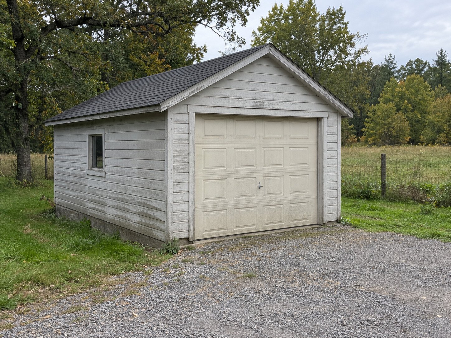 Weathered single-car timber garage before teardown.