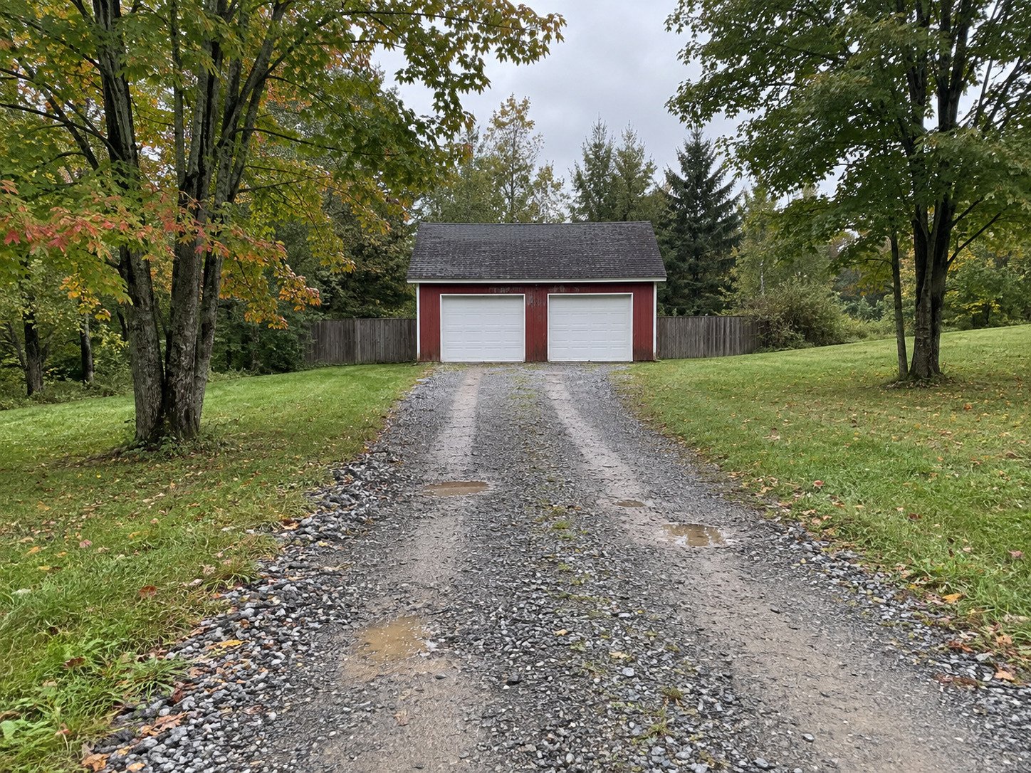 Rutted rural gravel driveway before grading.