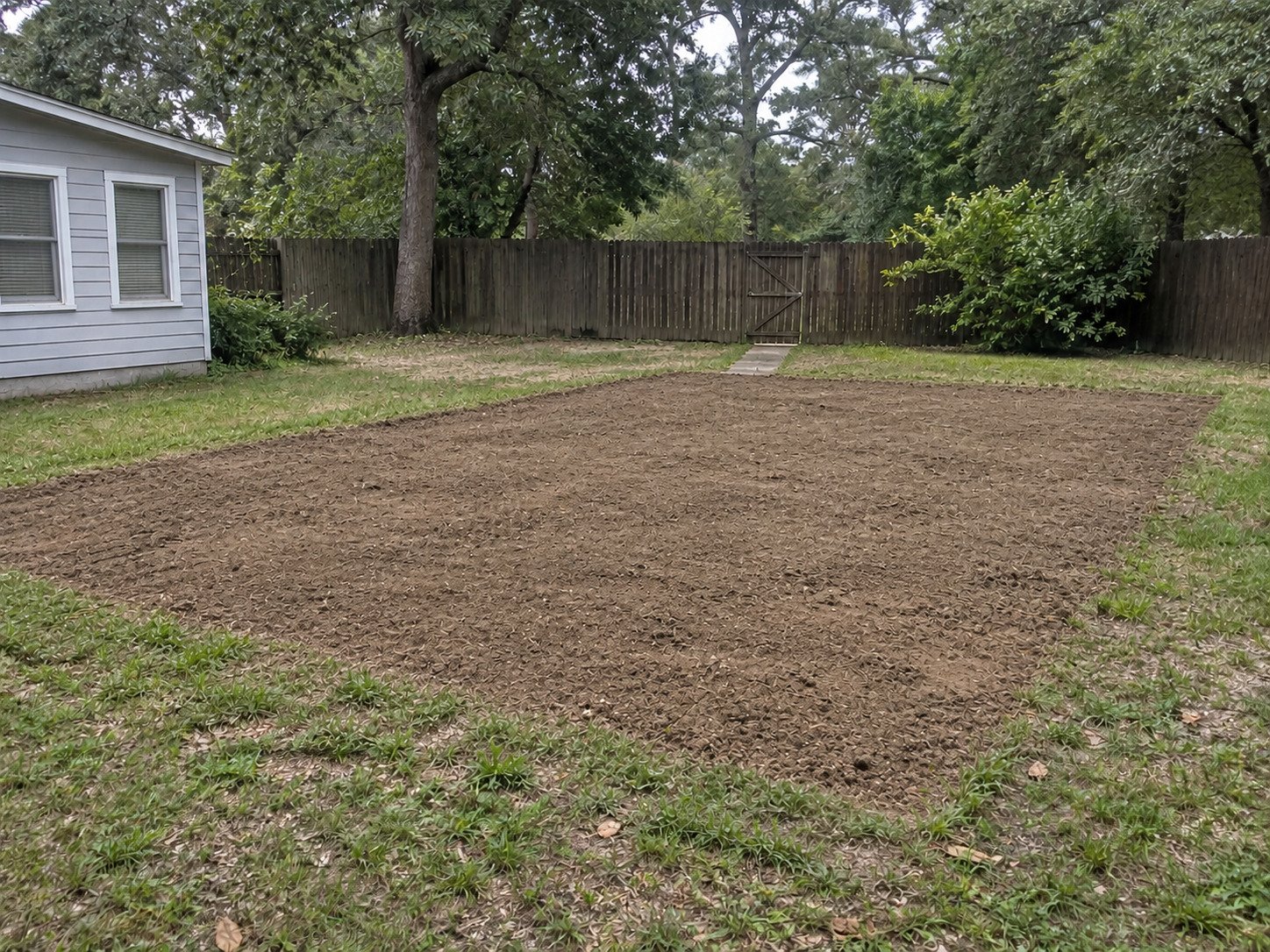 Backfilled level soil where the inground pool and coping were removed.