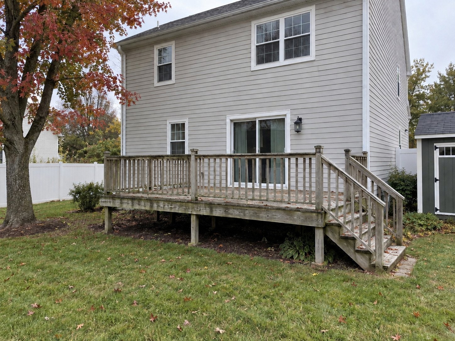 Empty weathered wood deck before replacement.