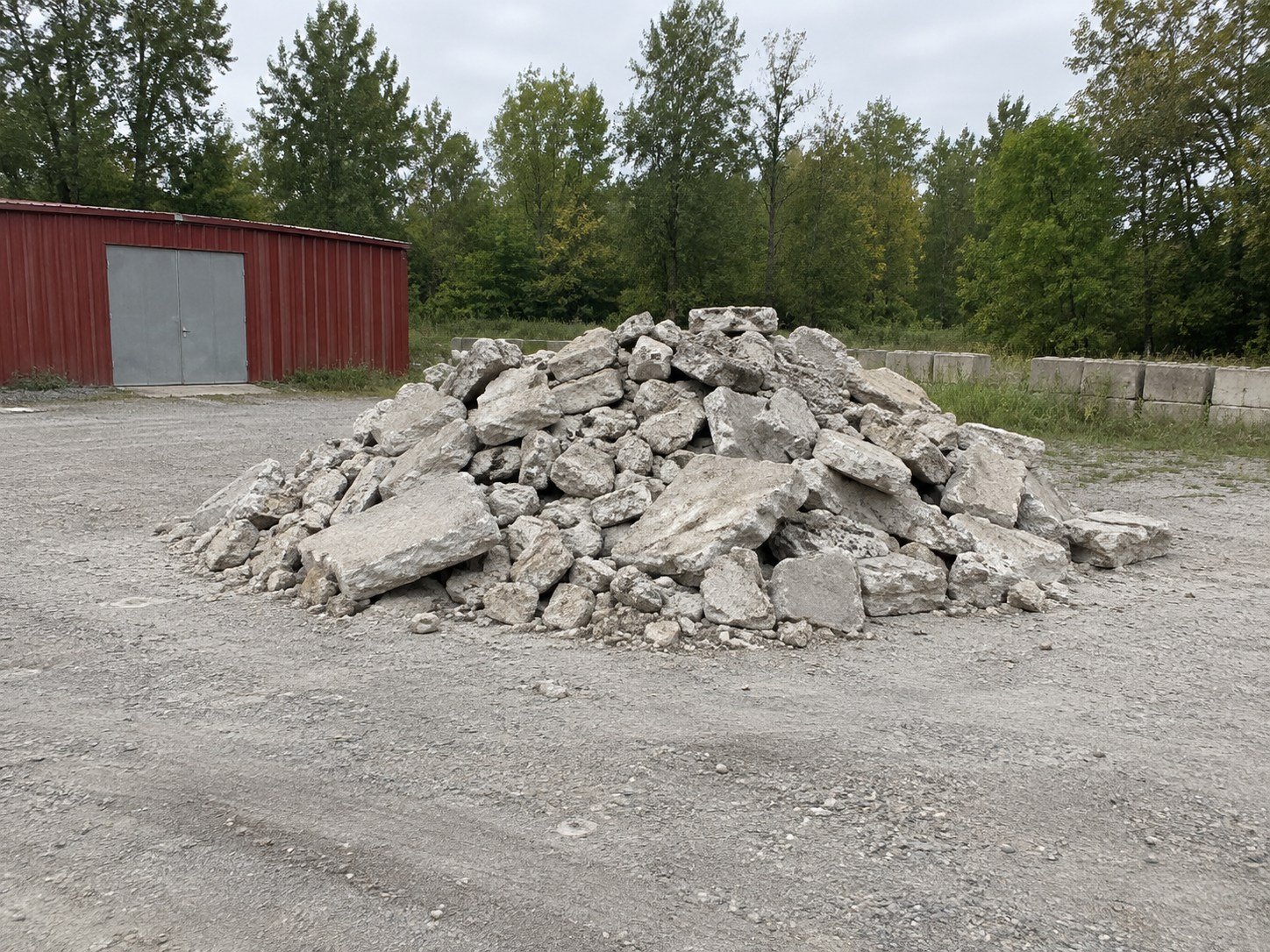 Separated large concrete rubble in an open contractor yard.
