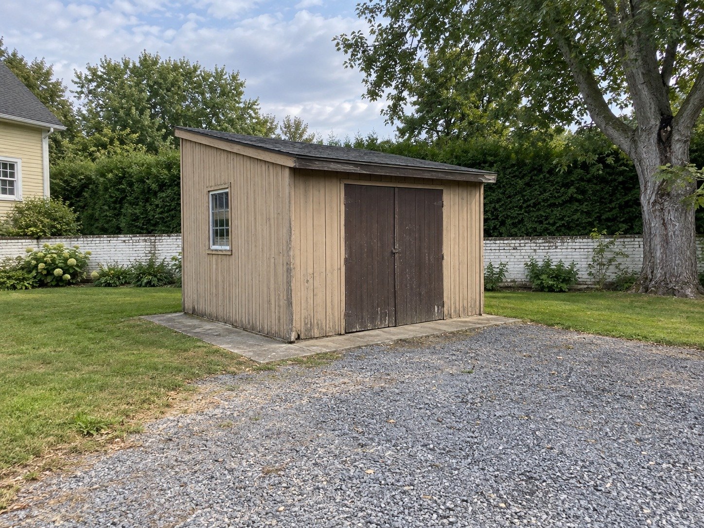 Old timber workshop at a gravel service court before demolition.
