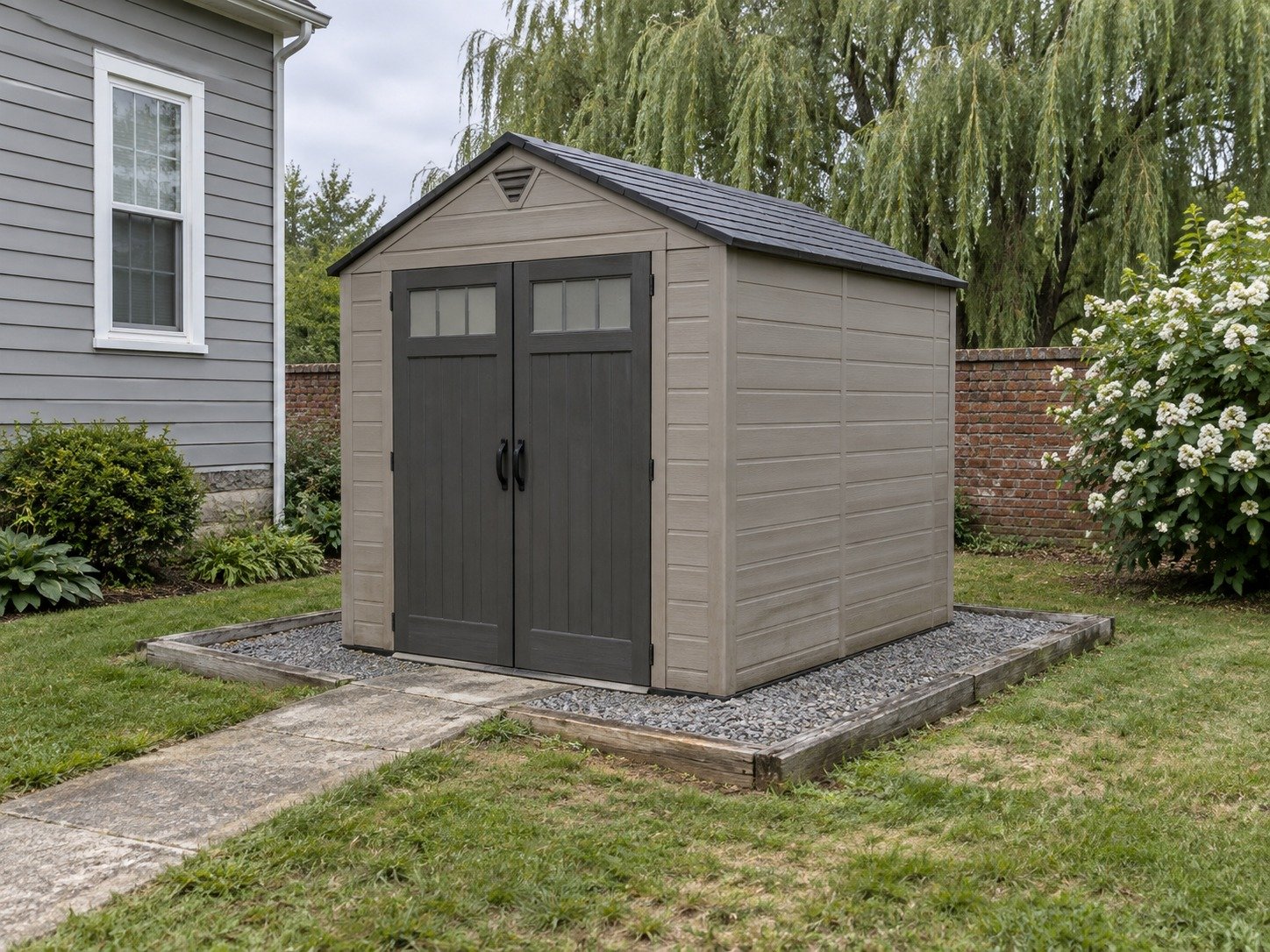 Unwanted resin storage shed on a timber-edged gravel base before removal.