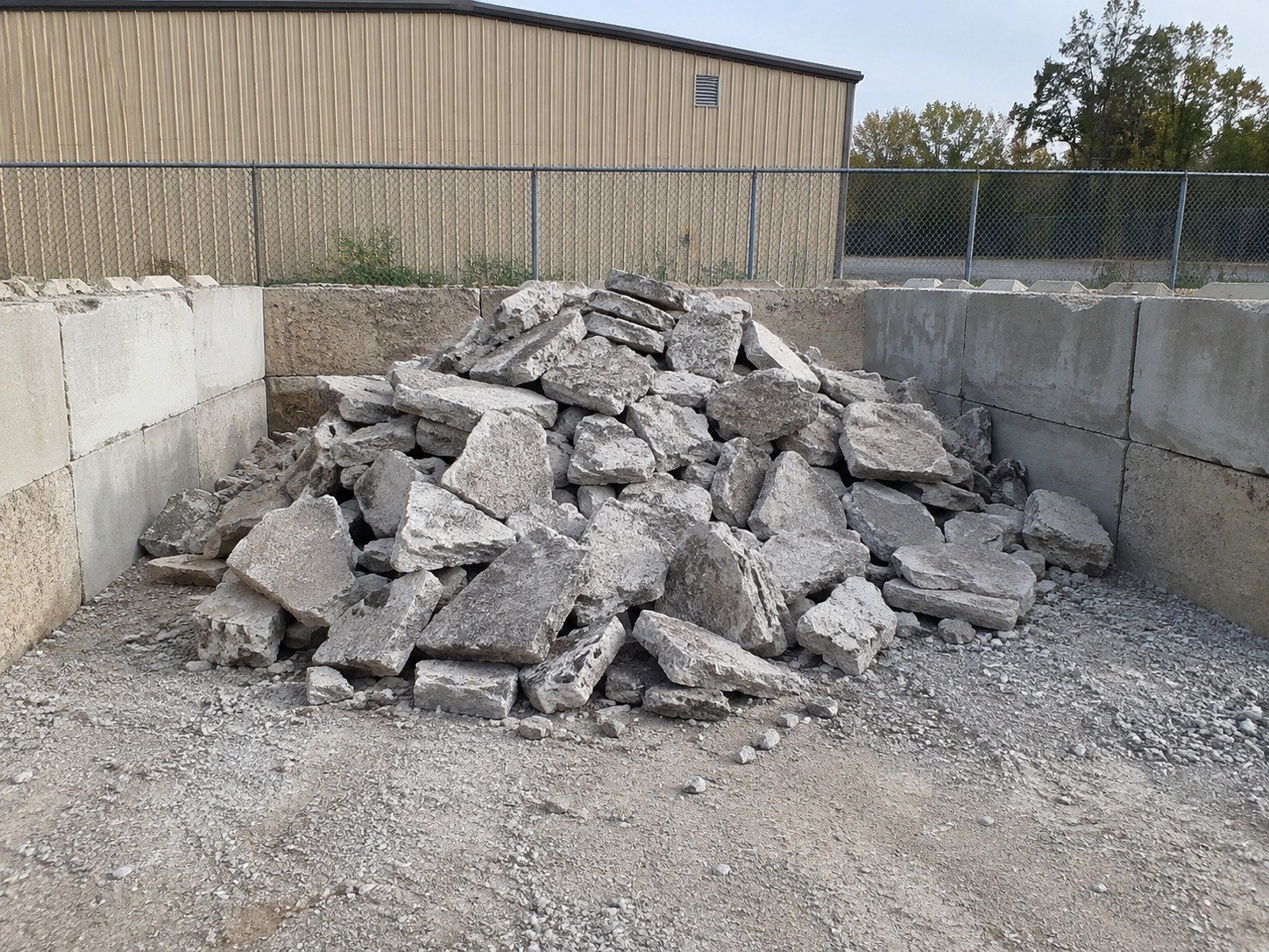 Large clean concrete fragments in a recycling bay before crushing.