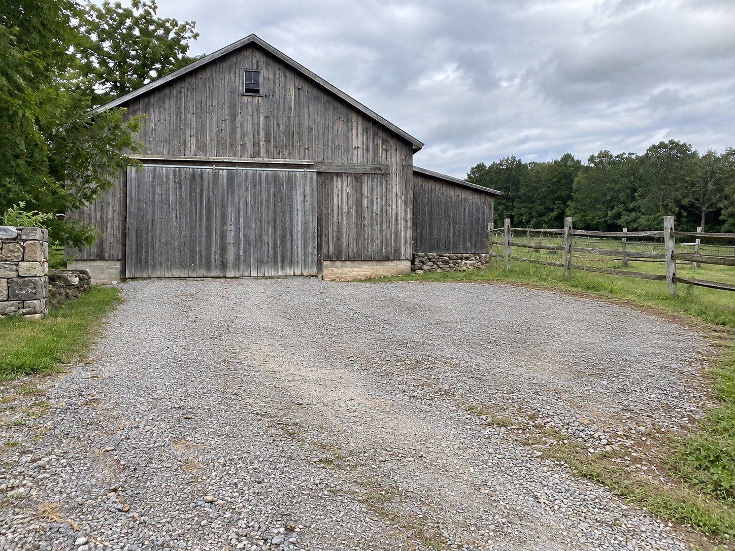 The same barn access after earth removal and a graded aggregate turning area.