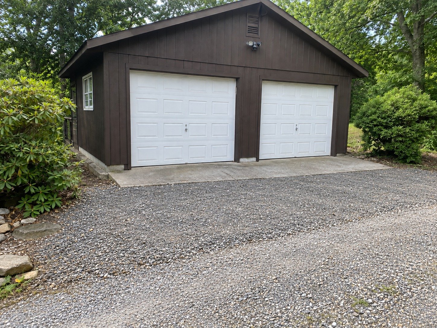 The same garage entrance after shallow excavation and aggregate-base preparation.