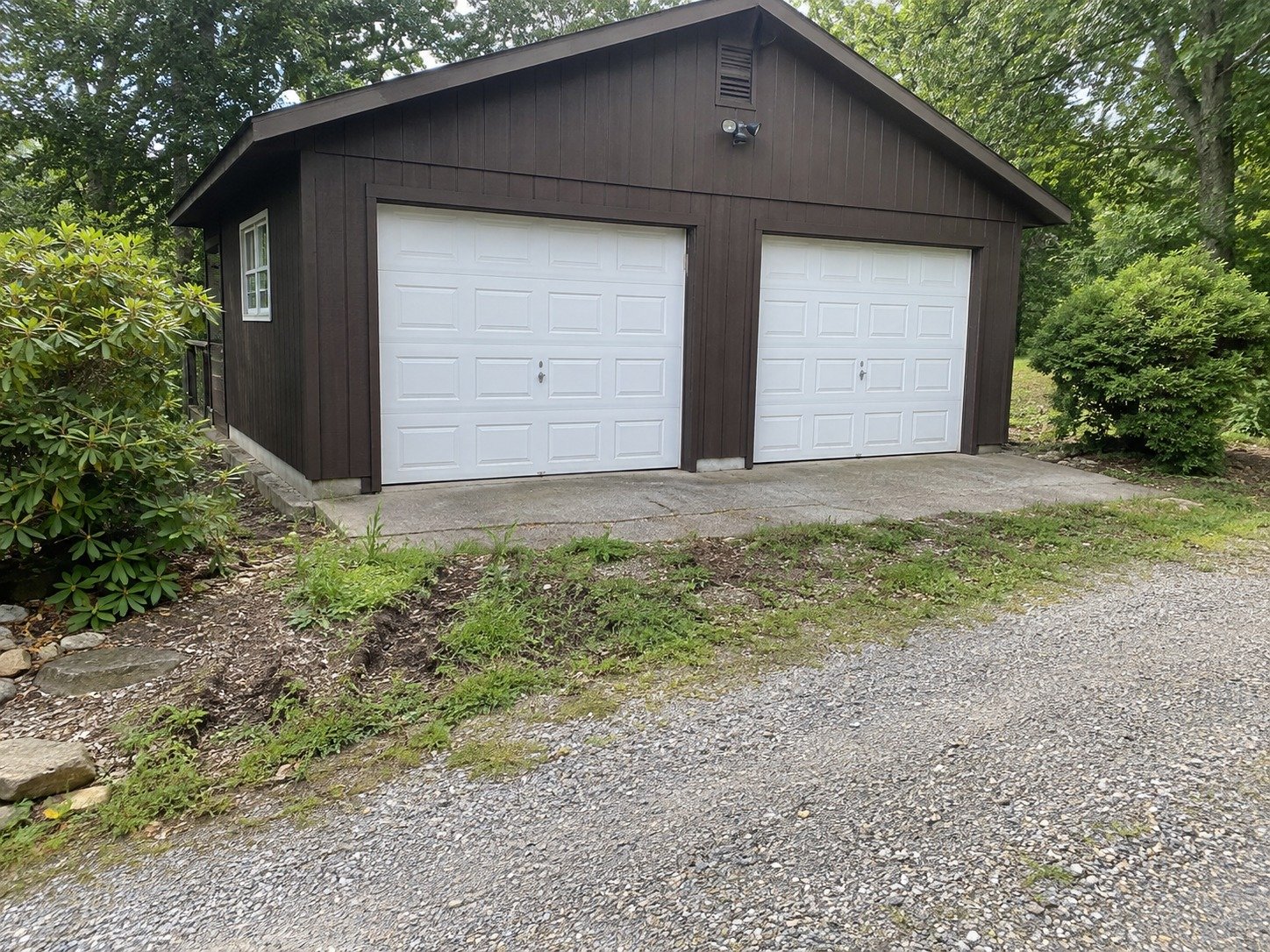 Uneven ground at a detached garage entrance before site preparation.