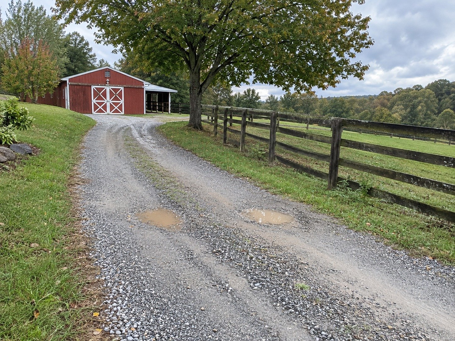 Rutted gravel farm driveway before grading and resurfacing.
