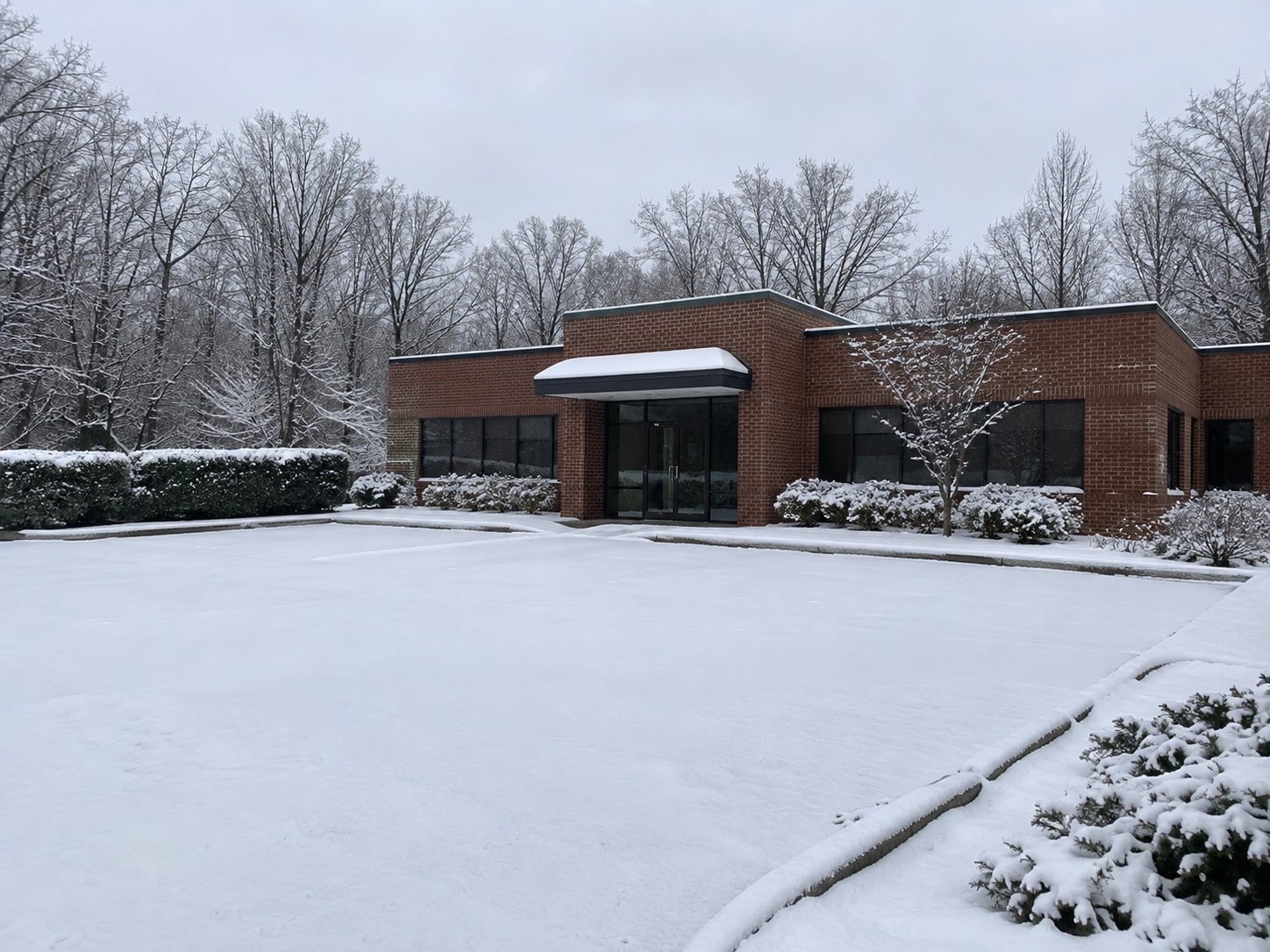 Representative commercial snow and ice site before the work.