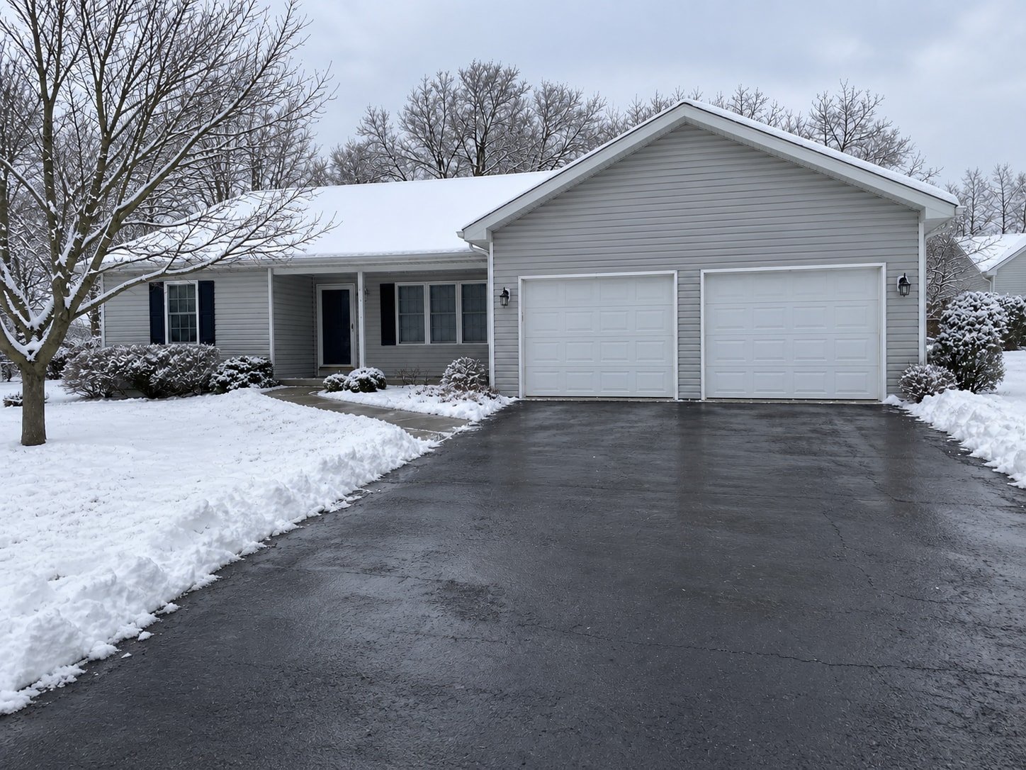 The same representative property after residential snow plowing, photographed from a nearby changed viewpoint.