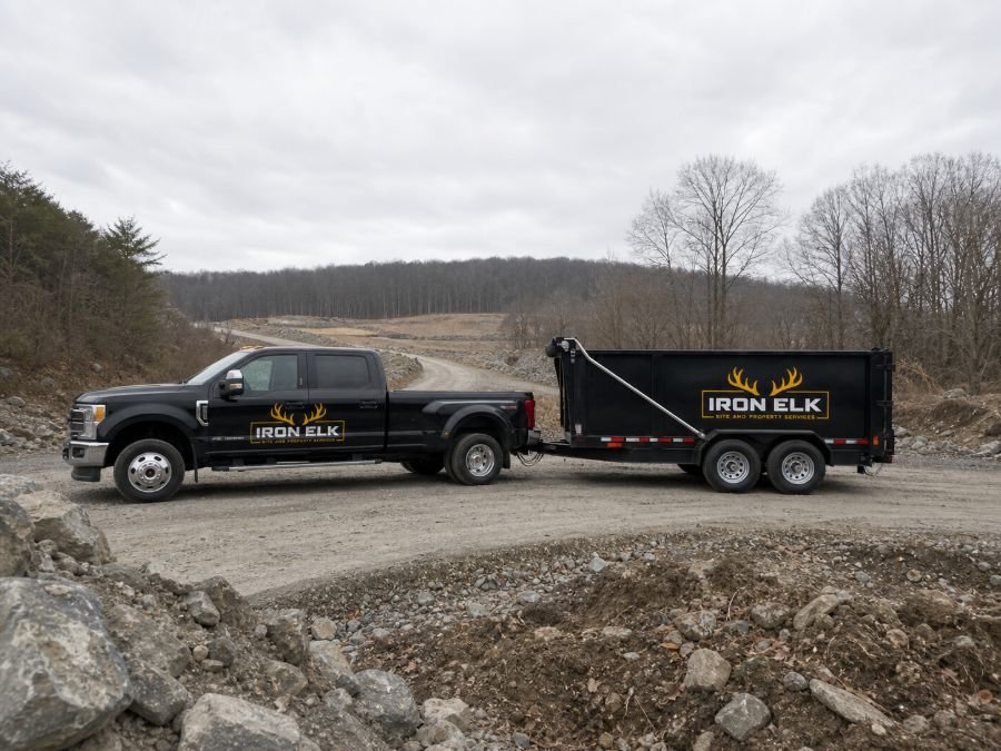 The truck and loaded trailer pulling in at a quarry-side disposal site.