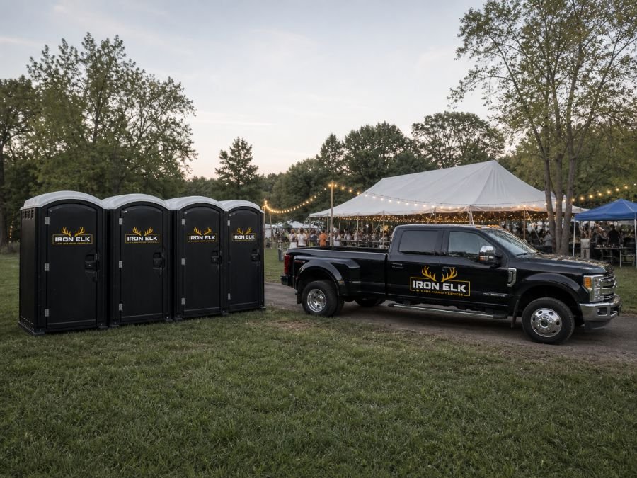 A row of portable toilets at an outdoor event.