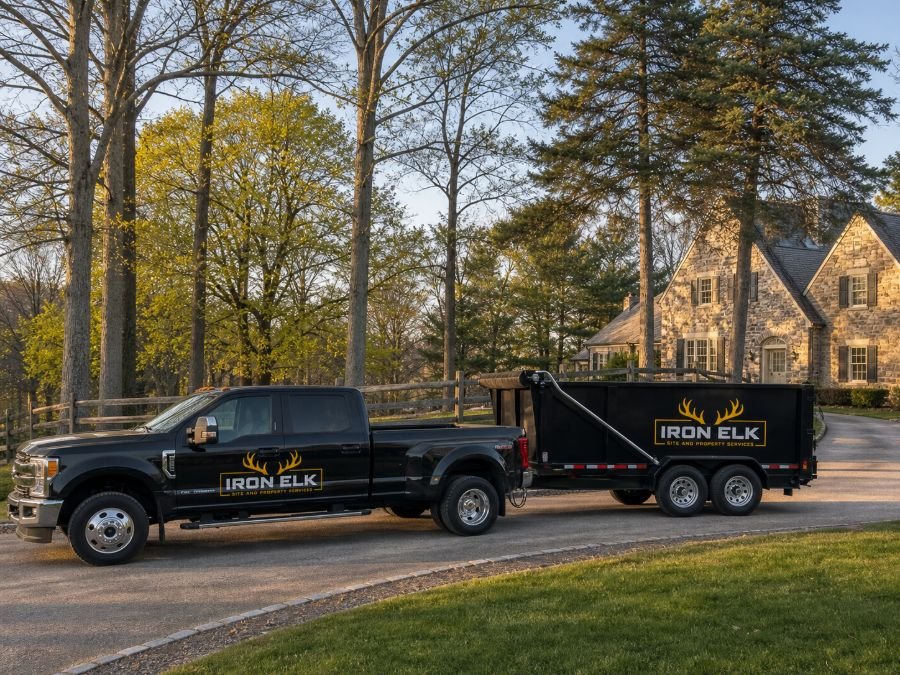 The truck and trailer parked in a residential driveway.
