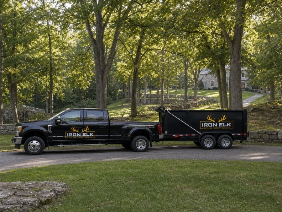 The truck and trailer parked in a residential driveway.