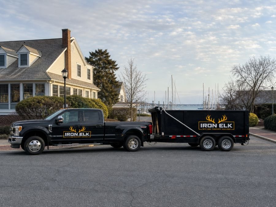 The truck and trailer parked in a residential driveway.