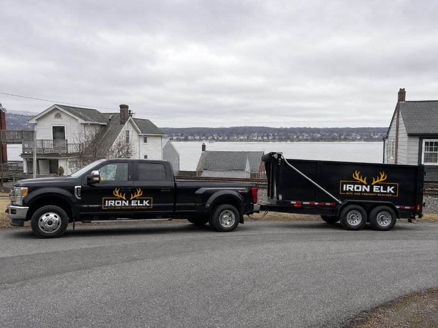 The truck and trailer parked in a residential driveway.