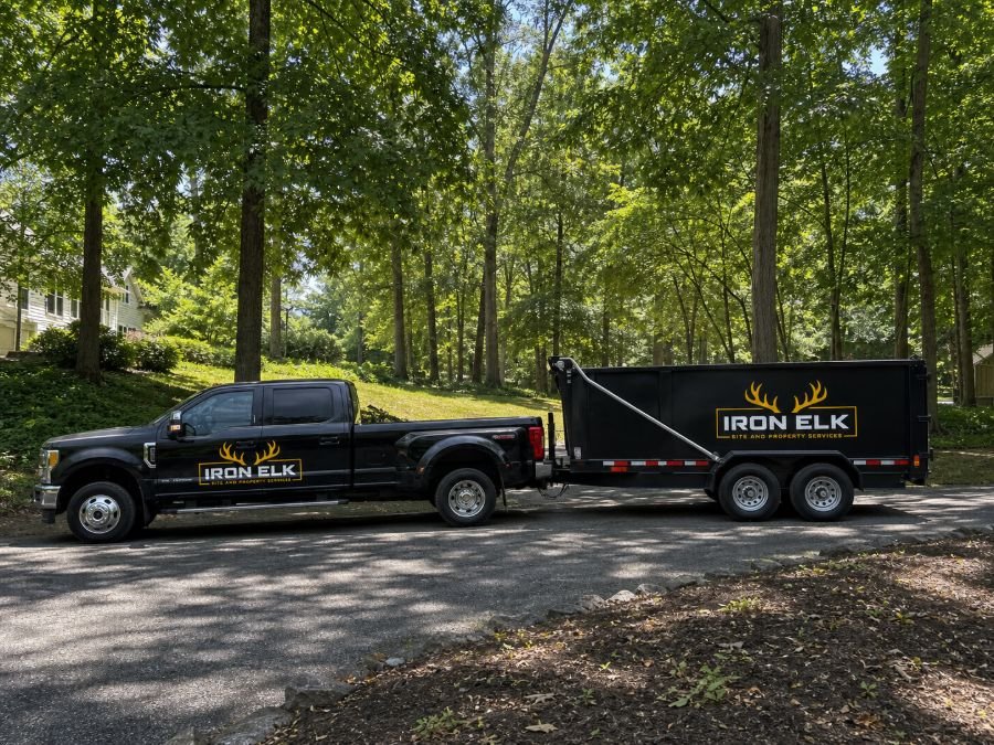The truck and trailer parked in a residential driveway.