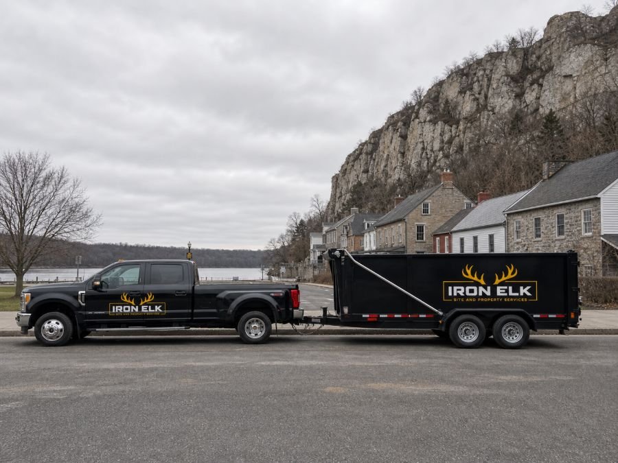 The truck and trailer parked in a residential driveway.