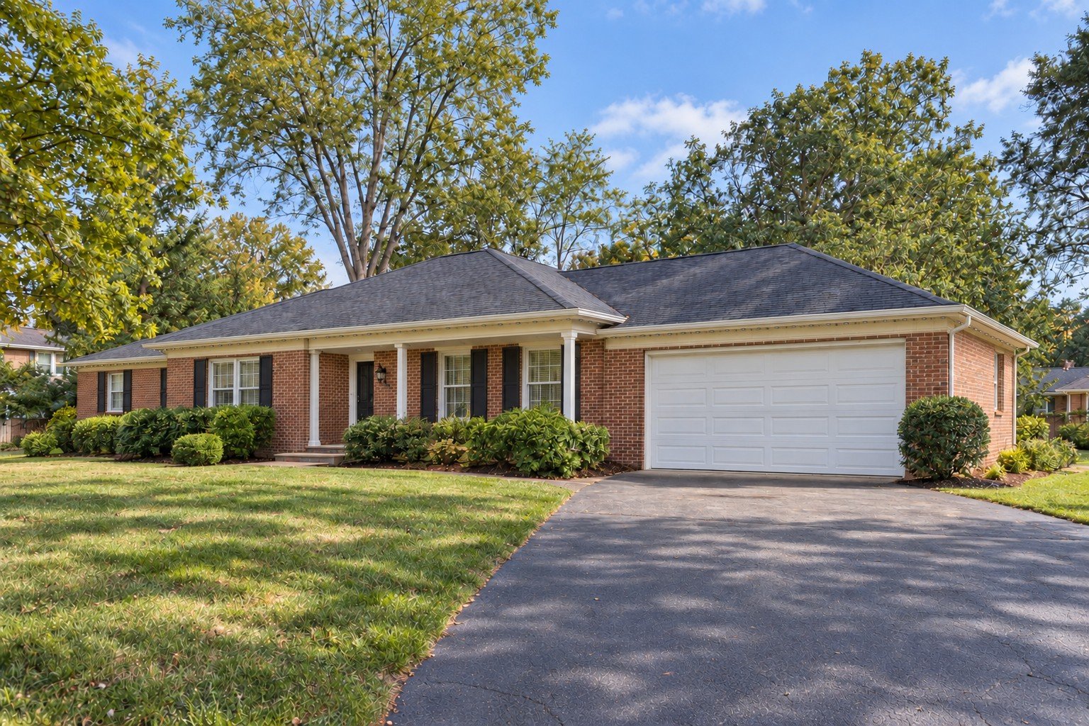 Daylight view of the same brick ranch, with its permanent-lighting hardware switched off.