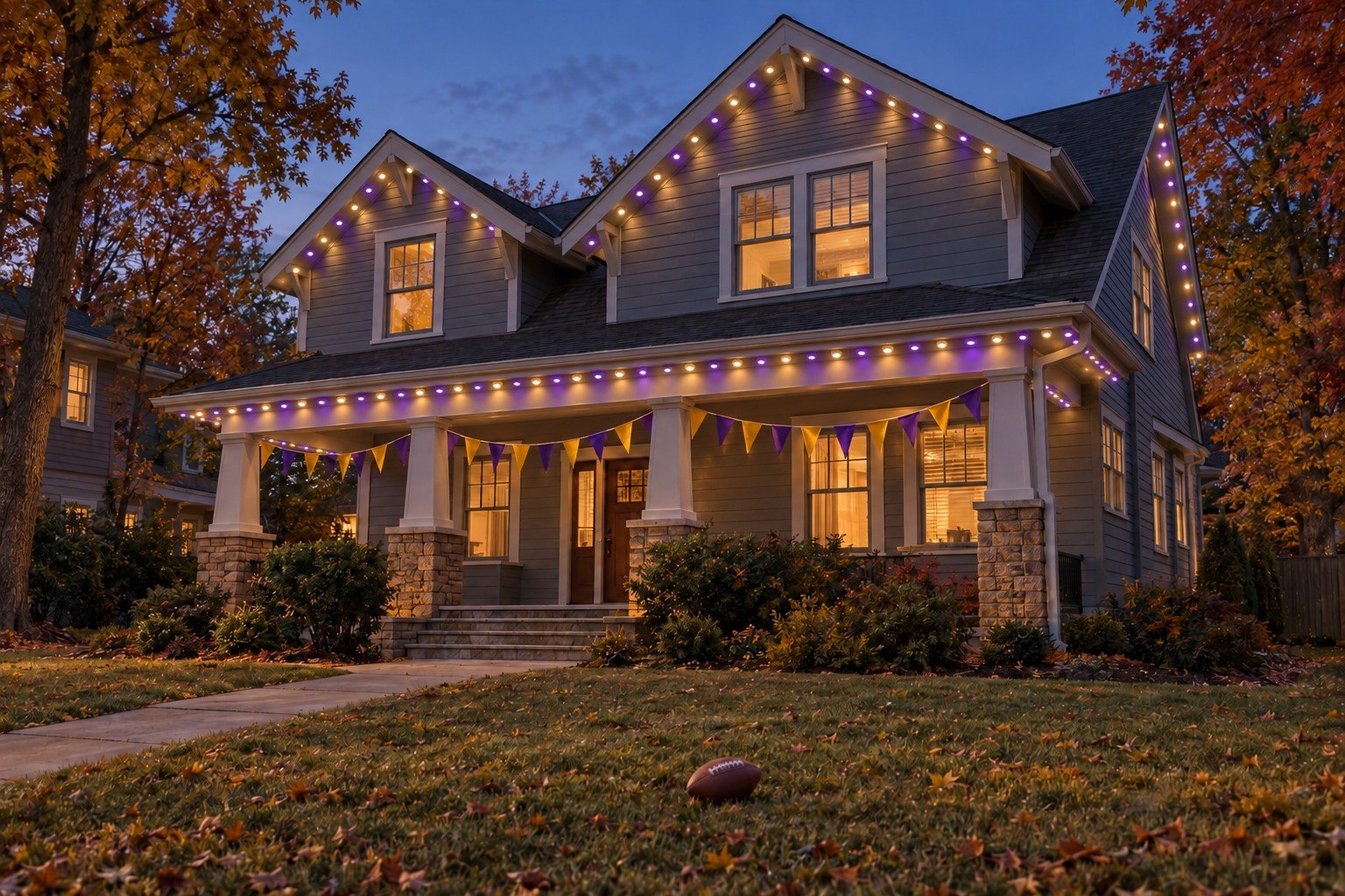 Craftsman home in purple and warm-white permanent lighting, with fabric pennants for football game day.