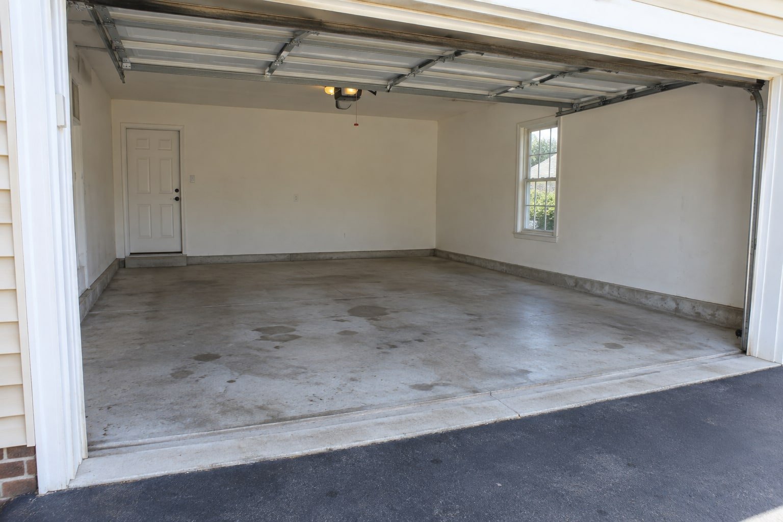 Emptied two-car garage with a bare concrete floor.
