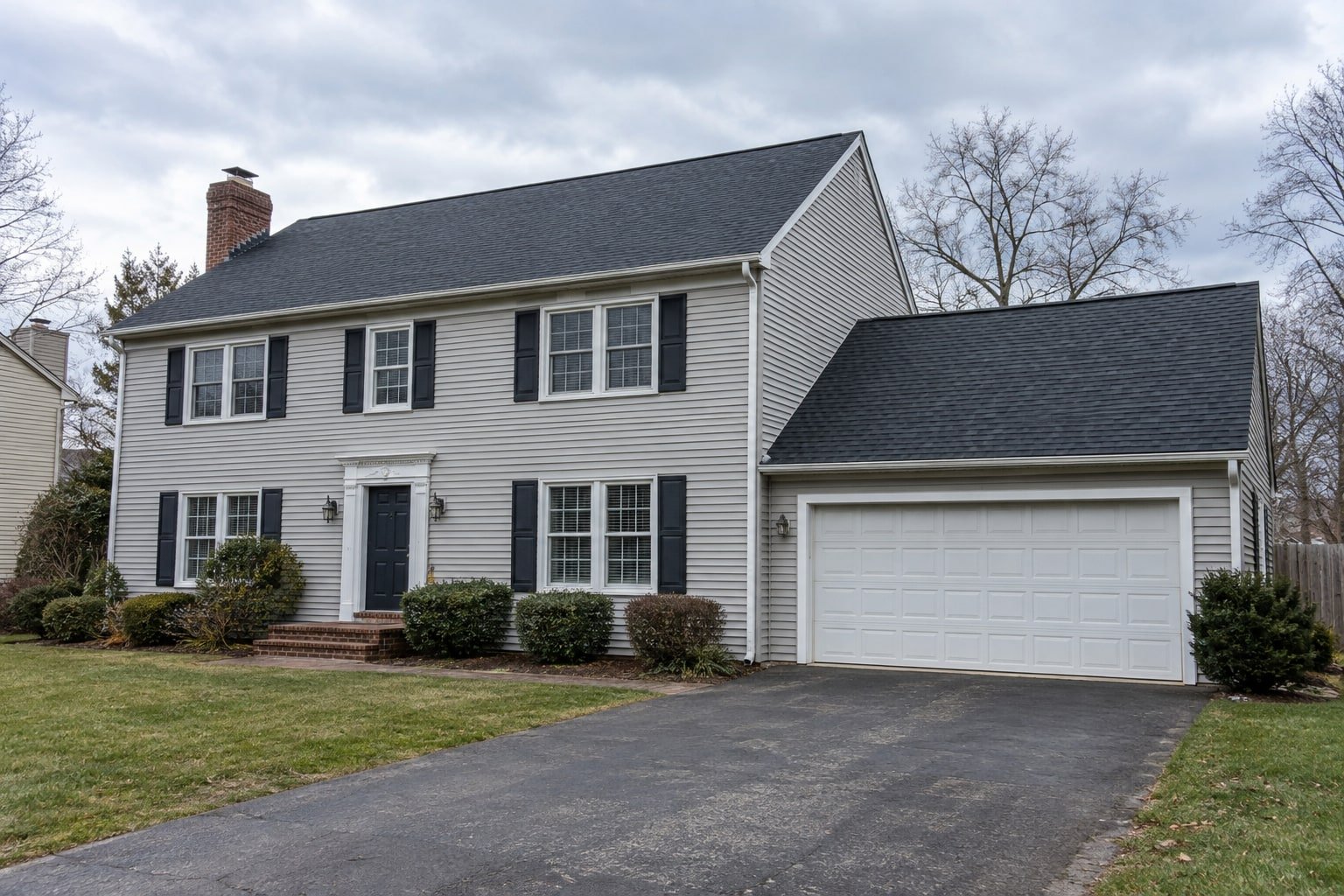 Two-story colonial home with an attached garage, representing a larger or two-story cleaning.