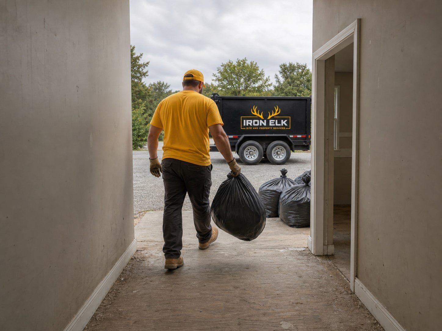A cleared hallway with full bags staged by the door.