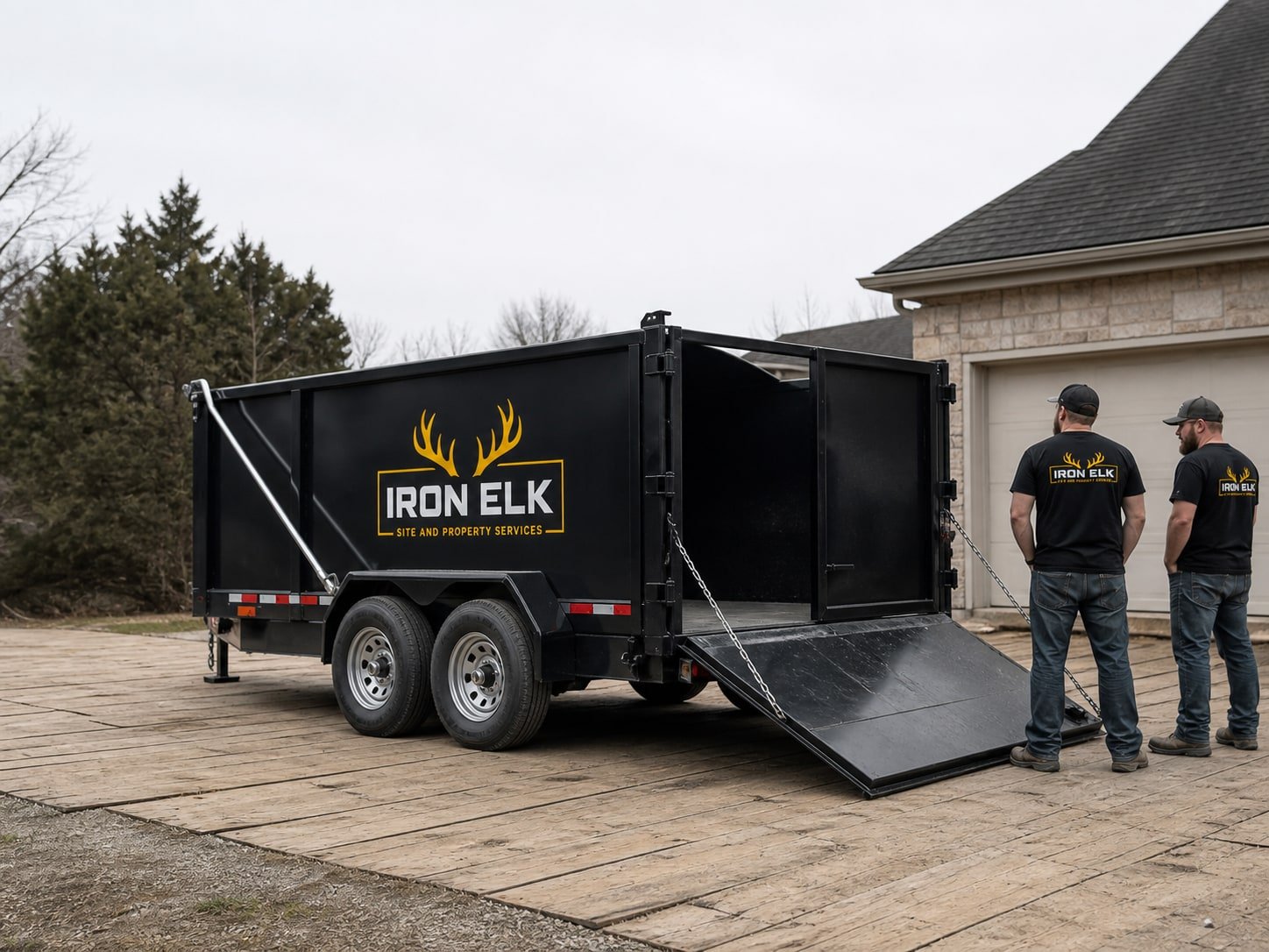 The 17-yard trailer with the load door open in a driveway.