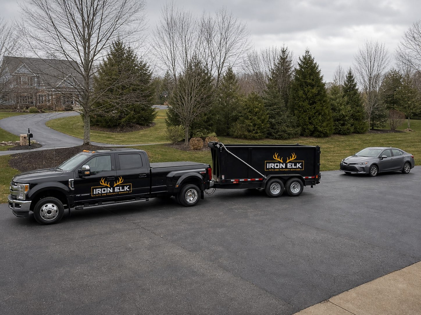 The 8-yard trailer hitched to the dually in a driveway.