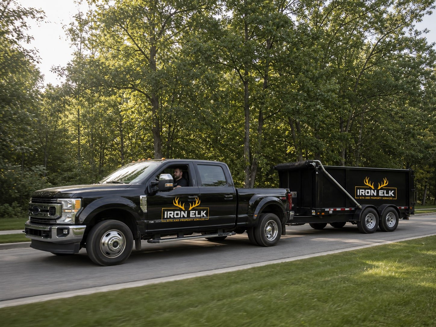 The dually towing the trailer down a residential street.