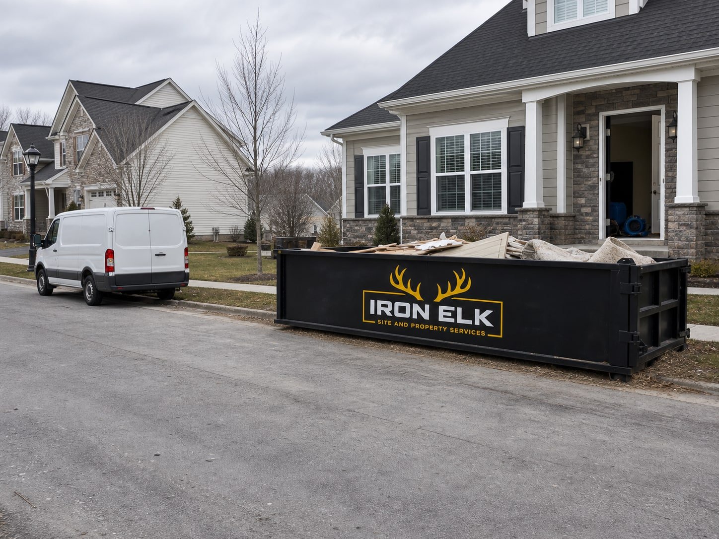 A container beside a house with mitigation equipment out front.