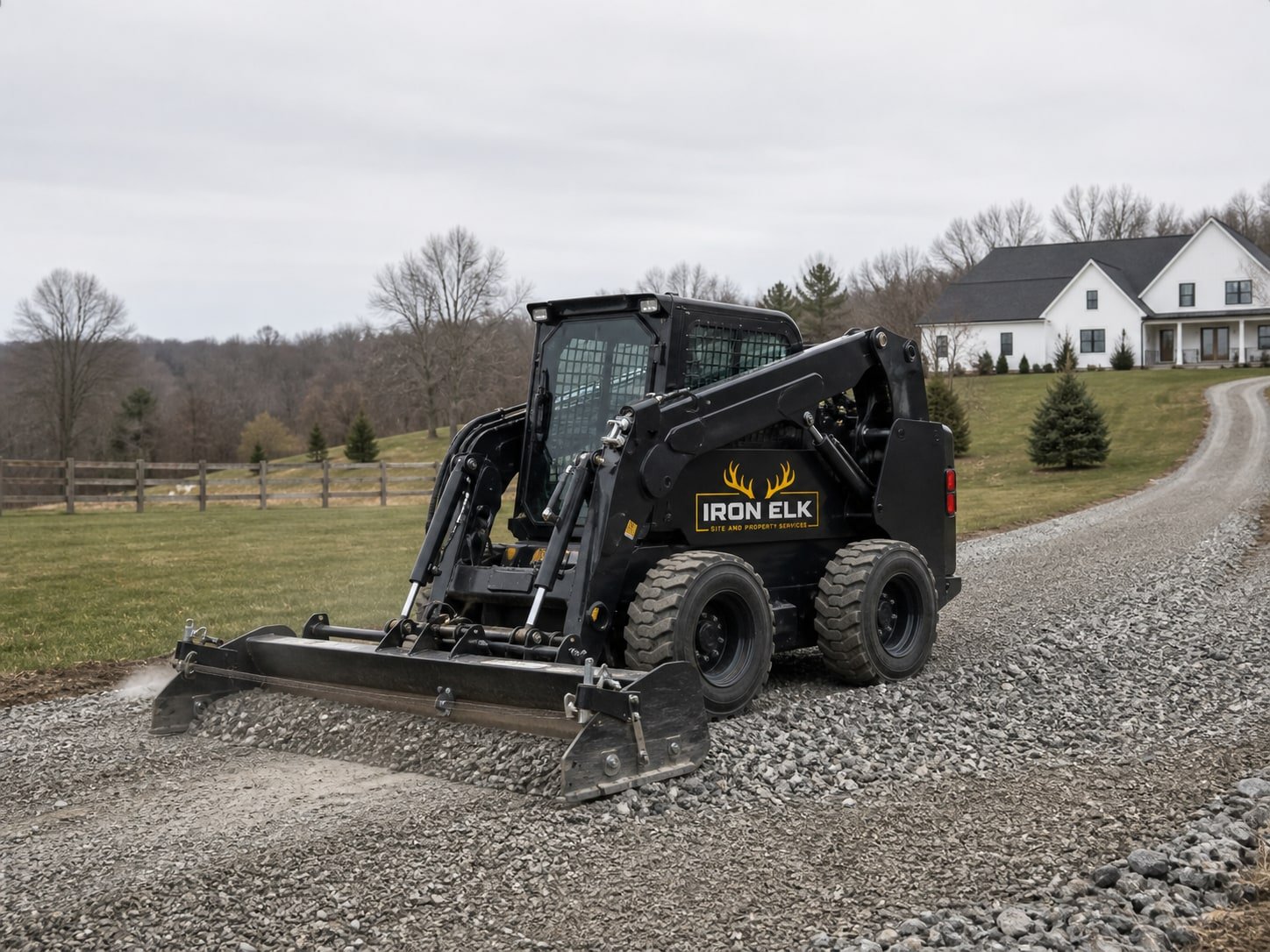 A skid steer grading a gravel driveway.