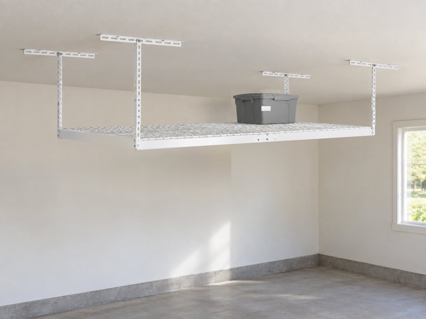 Example overhead storage: a white ceiling-mounted wire deck rack with a gray tote on the deck.